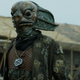 A Sea Devil from Doctor Who, standing in the middle of a village.